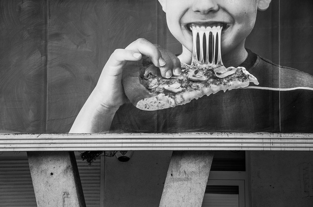 Adam Mazek Photography pizza Warsaw 2016. Boy eating pizza.