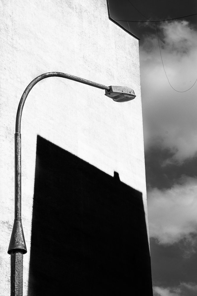 Adam Mazek Photography "Back to the past" Warsaw 2017. Street lamp and the shadow on the wall. Concrete.