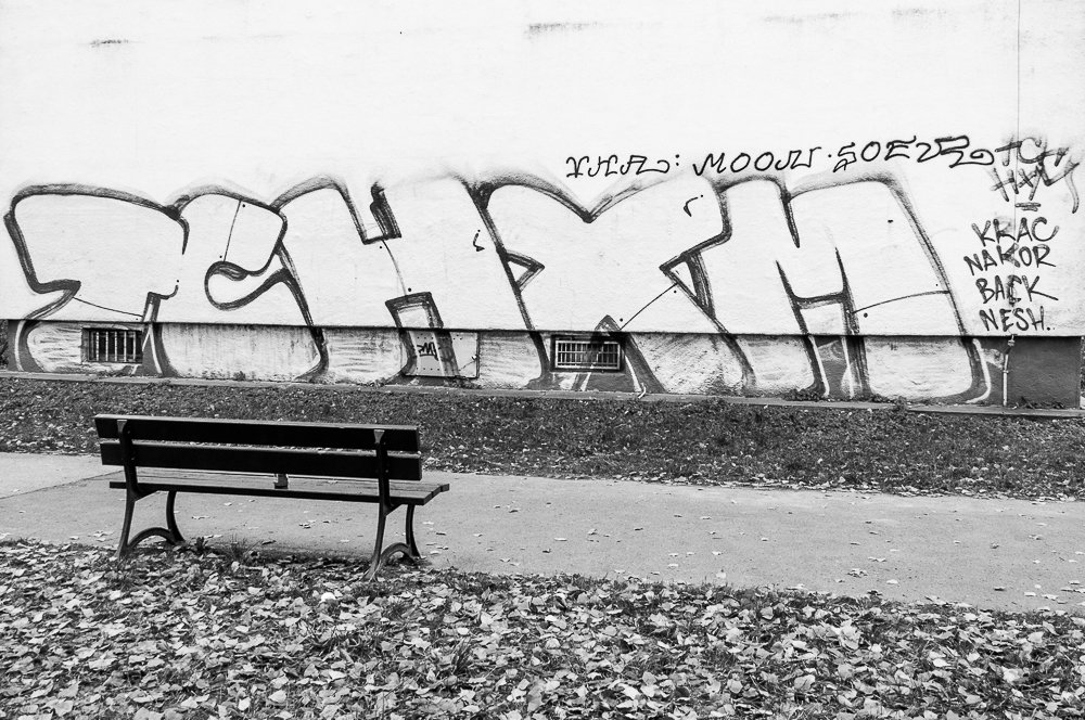 Adam Mazek Photography minimalism Warsaw 2016. Bench and the graffiti. Mokotow. Stegny.