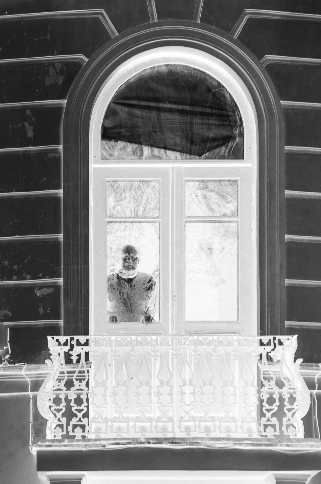 Adam Mazek Photography Vilnius 2016. Street photography. Negative. Silhouette in the window.