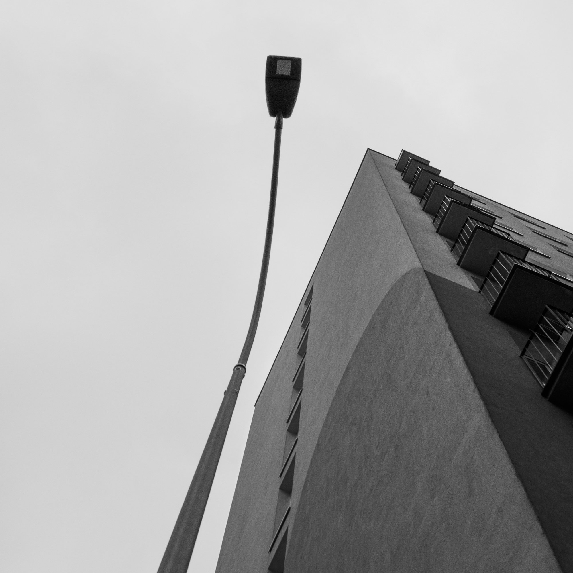 Adam Mazek Photography Warsaw 2018. Street lamps and block of flat. Square. Geometry. Minimalism.